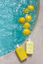 Load image into Gallery viewer, Sun Kissed and Goldie tanning oils by the pool with lemons